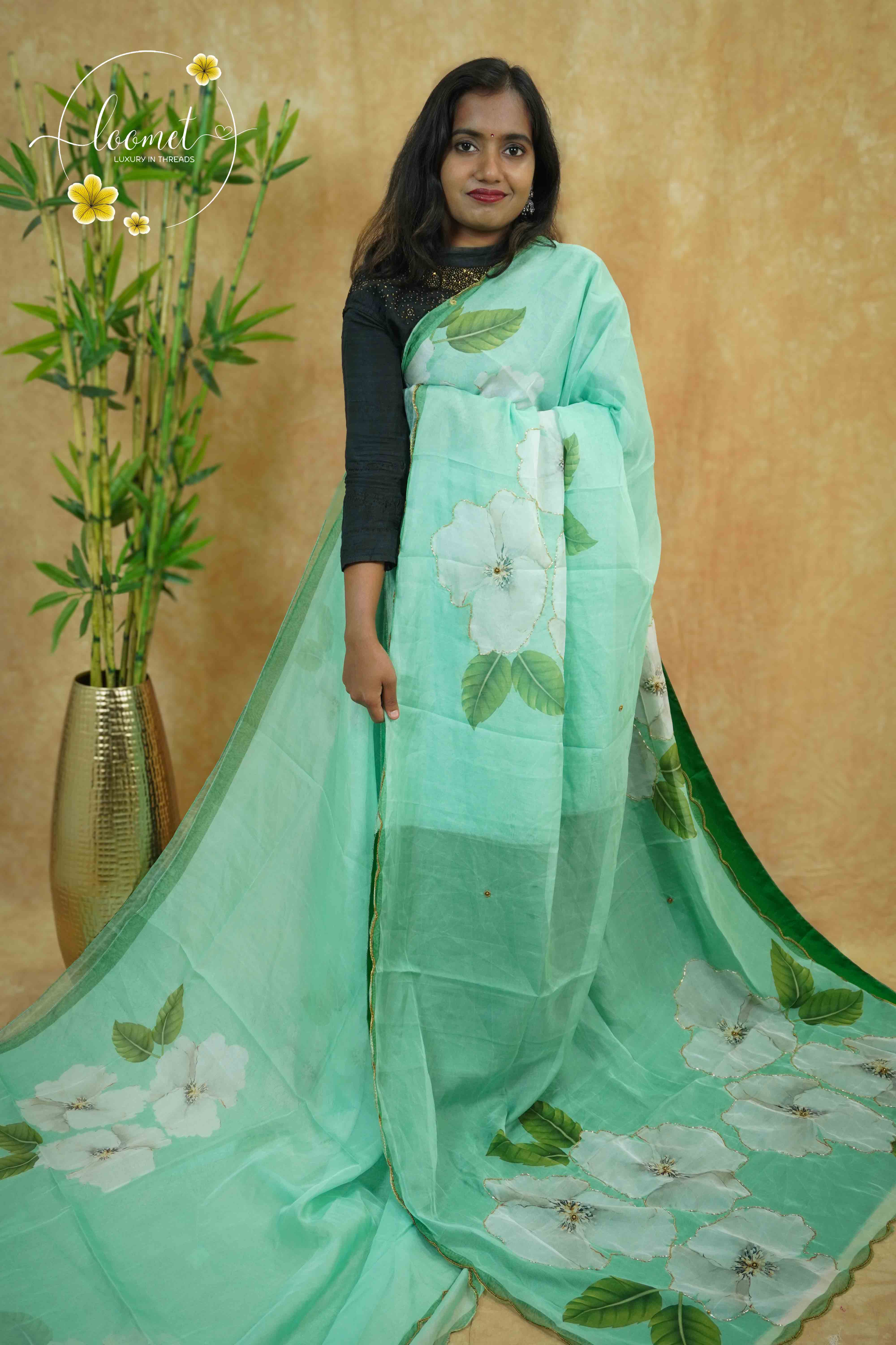 APL0203 Mint Green Semi Organza saree featuring digital floral printed with scalloped gold border.