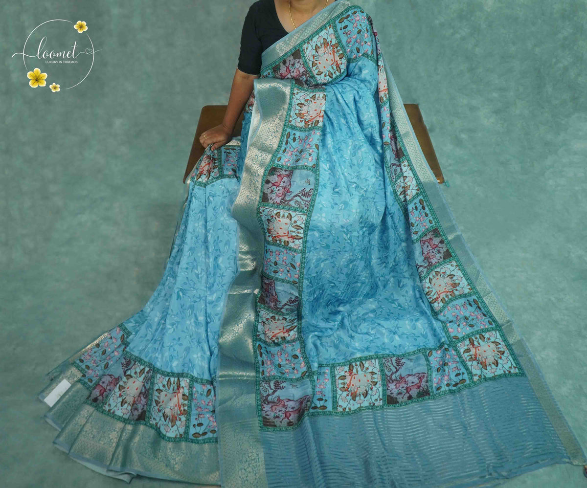 APL10301 Sky blue Viscose saree featuring Pichwai prints and silver zari.