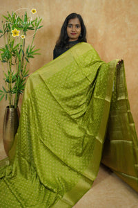 APL10701 Olive Green silky georgette saree with an all-over diamond (chowka) grid pattern.