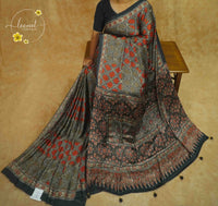 APL1121 Earthy Charcoal & Rust Semi Modal Silk saree with ajrakh print intricate geometric block prints and tassels.
