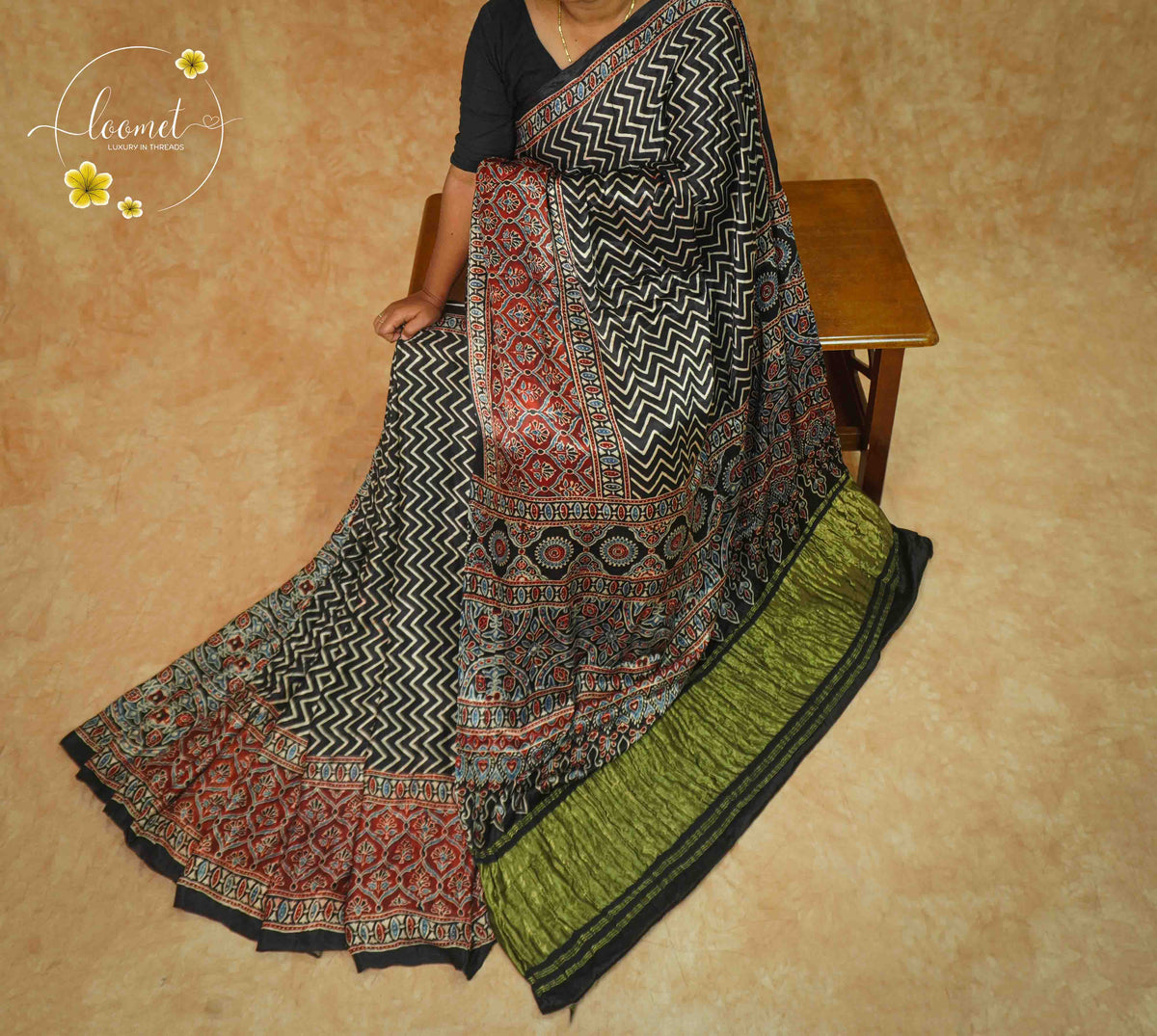 APL2025 Black Modal Silk saree featuring Chevron Ajrakh with Crimson Accents and Olive Green border.