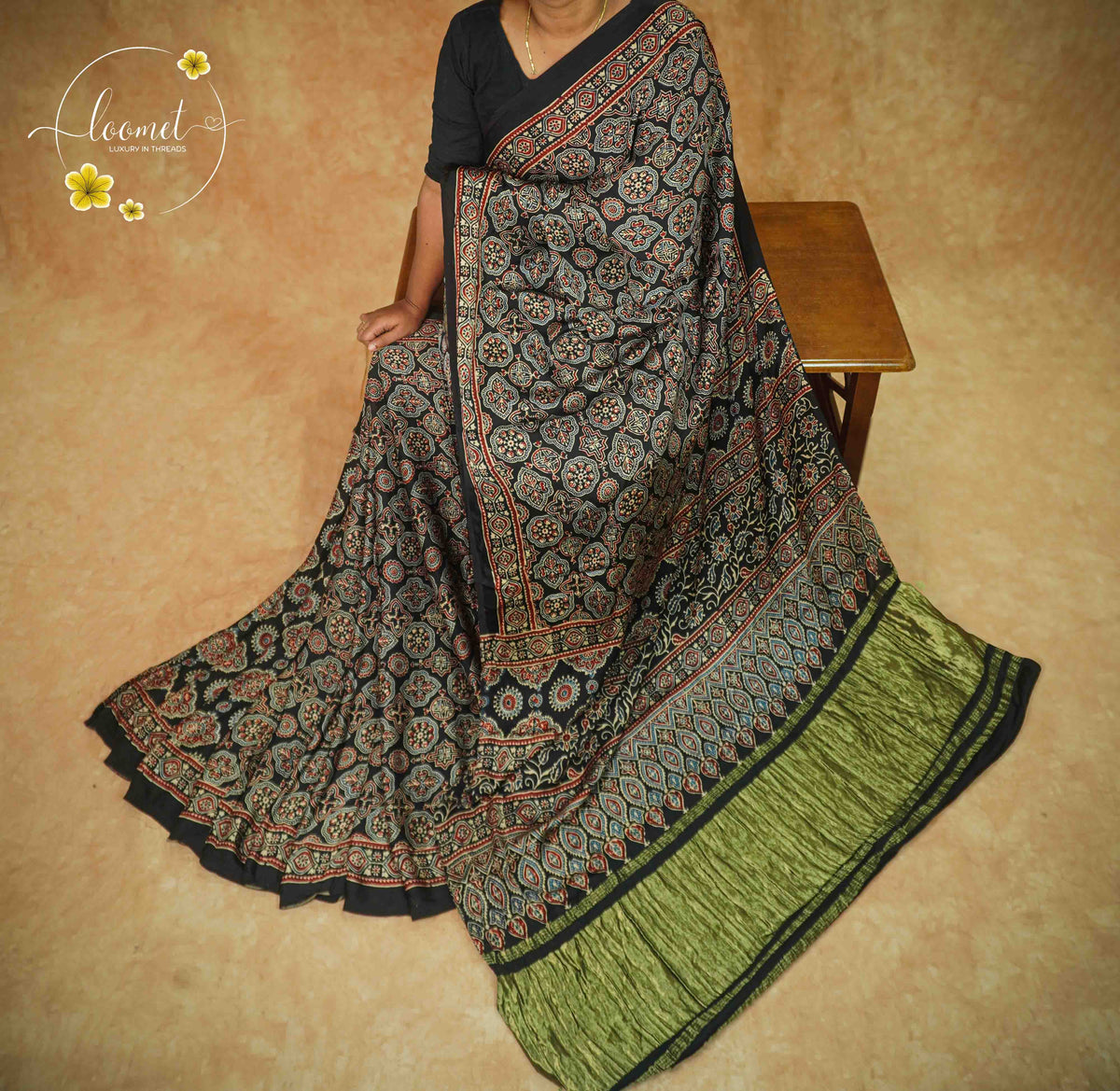 APL2026 Black Modal Silk saree featuring all-over Ajrakh block prints with Geometric Medallions and Olive-Green border.