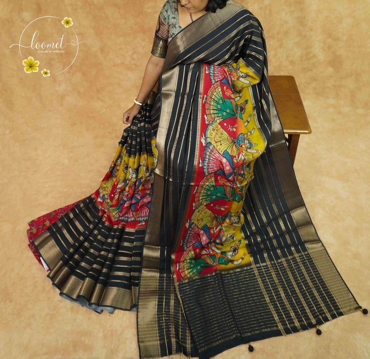 APL2101 Black Viscose saree featuring folk-dance narrative panels with gold zari stripes.