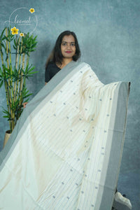 APL3102 Off-White Tussar silk saree with vertical dotted lines leafy buttas.