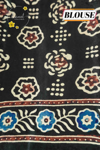APL4121 Black Modal Silk saree featuring all-over Ajrakh block prints with Geometric Chevrons and floral medallions.