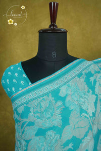 ARN1616 Cyan Blue Chiffon saree with all-over large floral prints.