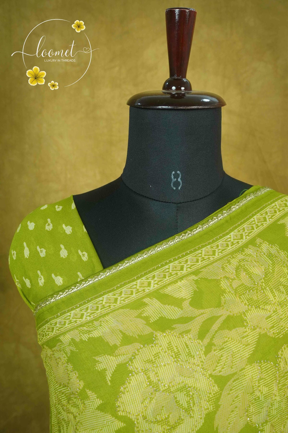 ARN1618 Olive green saree features detailed beige floral jacquard weaving, a patterned silver border, and matching tassels for an elegant finish.