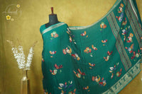 ARN21003 Emerald Green Georgette saree with multicolor floral bouquets.