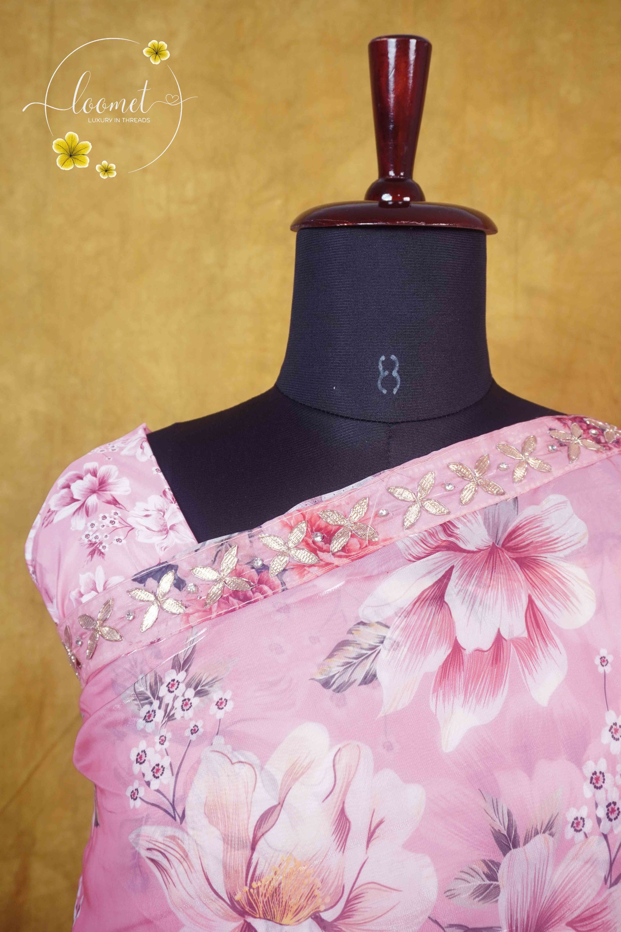 ARN2602 Blush pink saree features an all-over floral print with a sequined scallop border and matching tassels on the pallu.