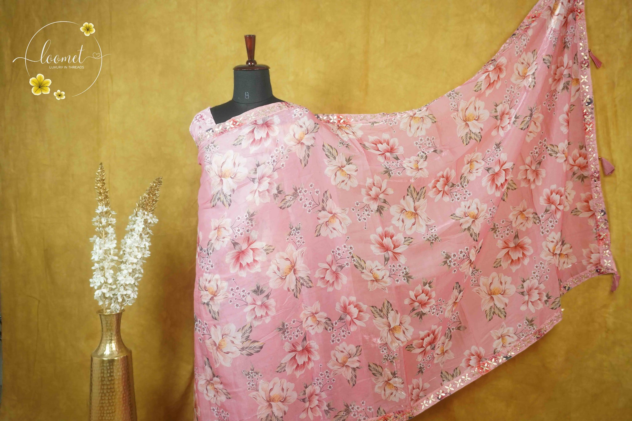 ARN2602 Blush pink saree features an all-over floral print with a sequined scallop border and matching tassels on the pallu.