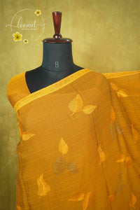 ARN3101 Mustard Yellow Jute Georgette saree with leaf motifs.