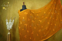 ARN3101 Mustard Yellow Jute Georgette saree with leaf motifs.