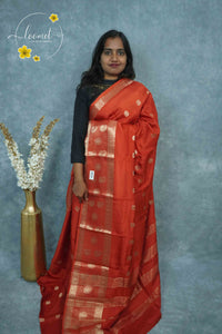 ARN3407 Rust Red Mysore Silk saree features floral buttas with zari paisley borders.