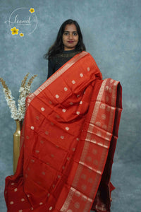 ARN3407 Rust Red Mysore Silk saree features floral buttas with zari paisley borders.