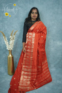 ARN3408 Deep Orange-Red Mysore Silk saree features floral buttas with zari paisley borders.
