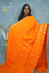 ARN3501 Orange Mysore Silk saree features floral and coin-shaped motifs.