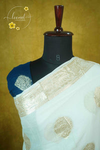 ARN4102 Off-white & teal blue Georgette saree with circular butta motifs.