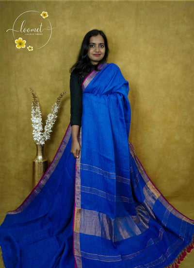 ASB2561 Royal blue Saree with a textured body featuring horizontal gold zari stripes, a broad gold zari vertical border and a contrasting fuchsia edge.