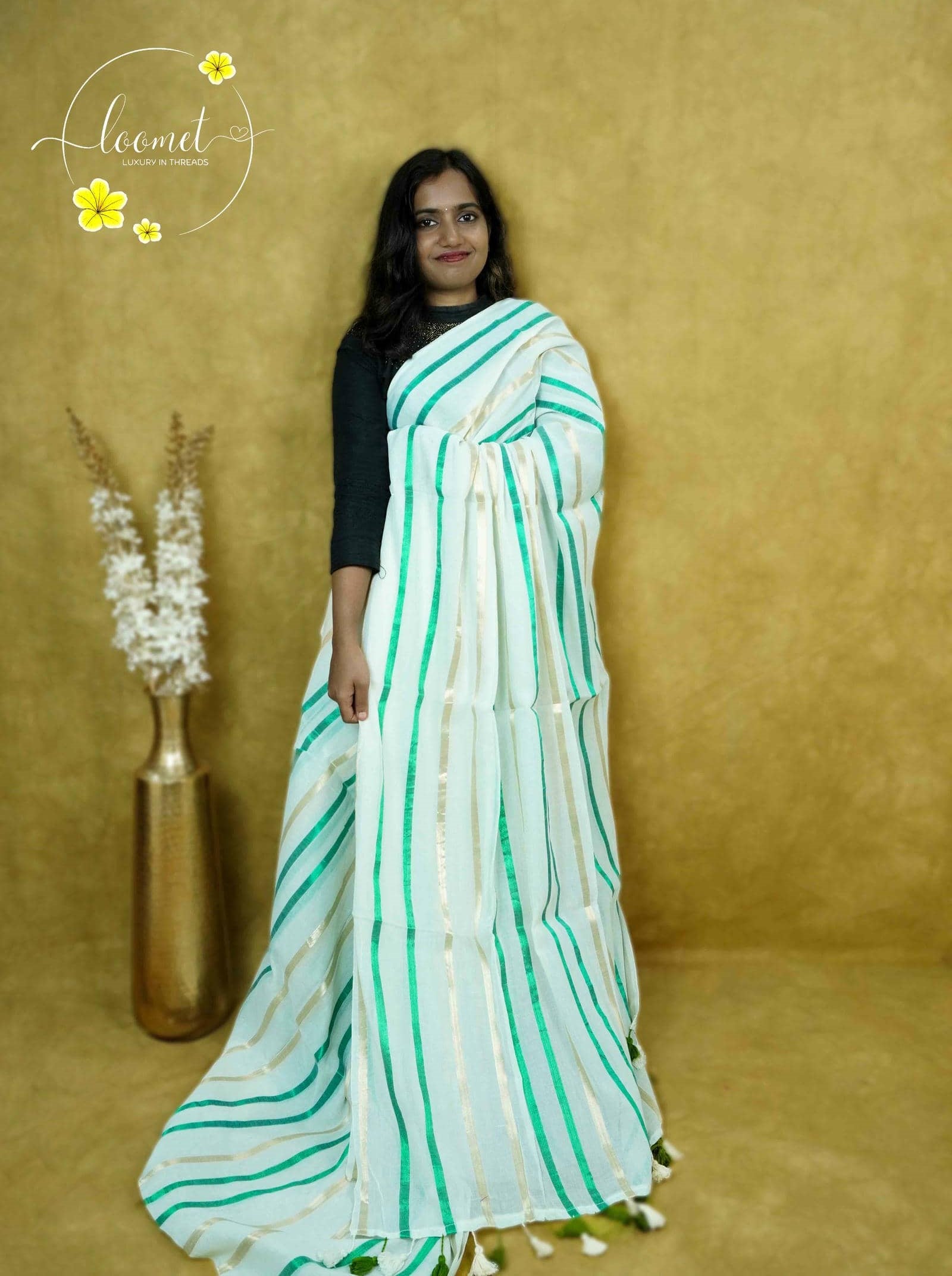 ASB25638 White saree with a minimalist design & vertical stripes in emerald green and soft beige finished with dual-coloured tassels.