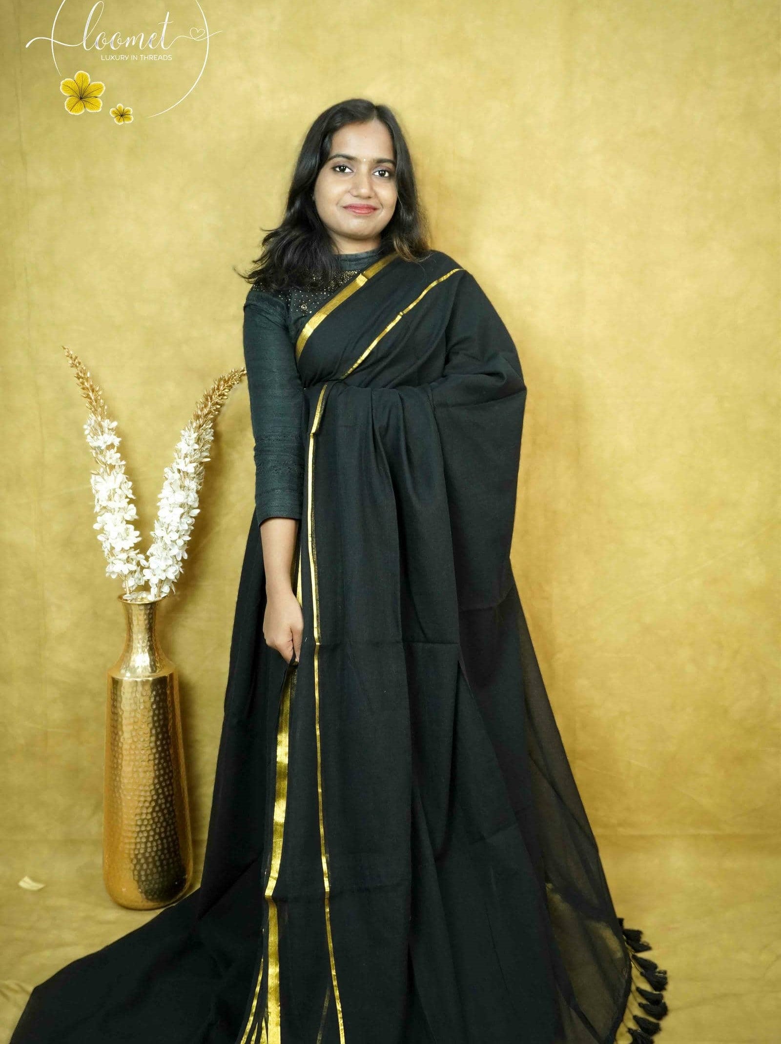 ASB25639 Matte black saree with a minimalist design broad gold zari border and a single thin vertical gold