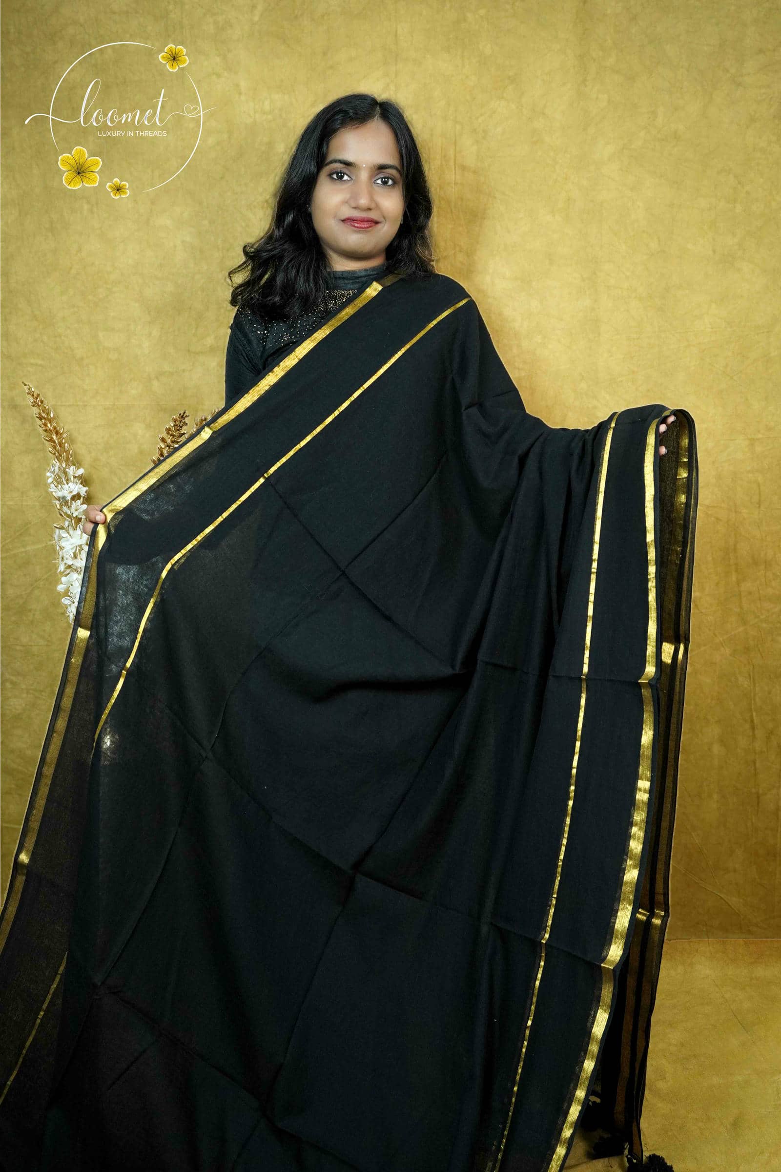 ASB25639 Matte black saree with a minimalist design broad gold zari border and a single thin vertical gold