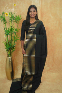 ASB25660 Matte Black Mul Cotton saree with vertical golden zari stripes.