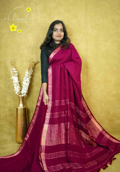 ASB2567 Deep maroon saree with textured body featuring fine horizontal antique gold stripes with vertical gold zari border and contrasting  matching tassels.