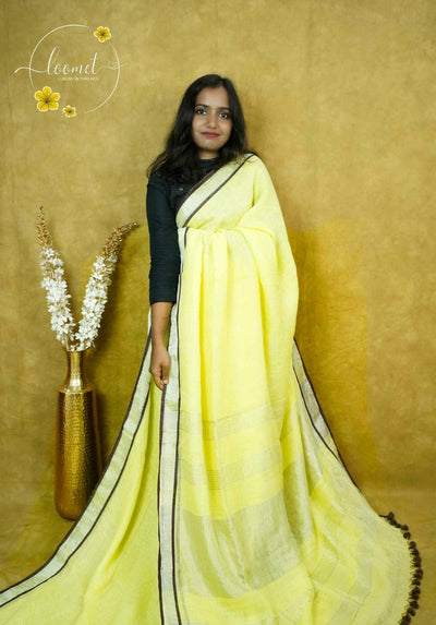 ASB2568 Lemon yellow with a minimalist design featuring a broad vertical gold zari border by thin strips of navy blue by matching blue tassels.