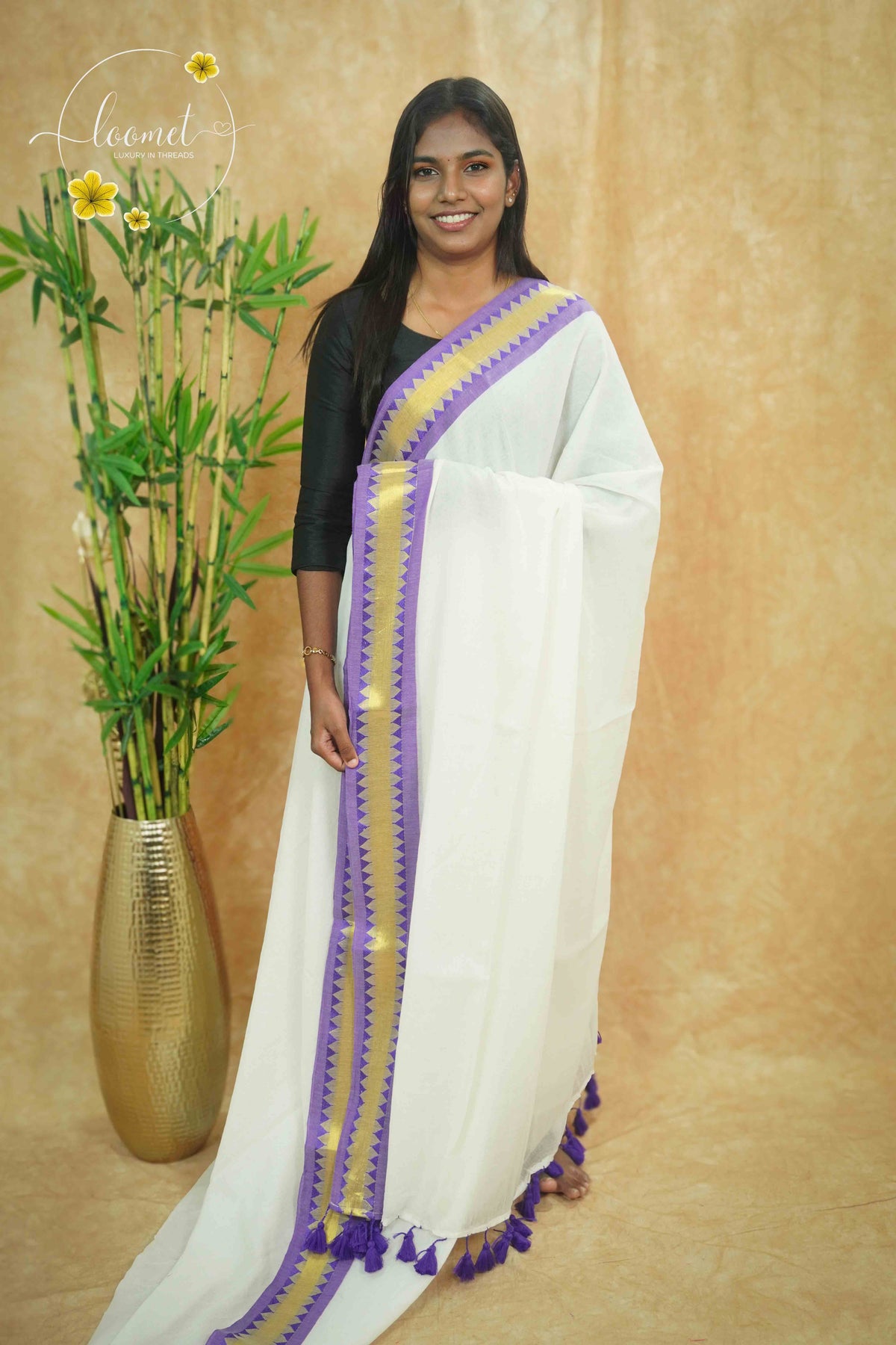 AWB7240 White mul cotton saree features a plain body with purple temple border.