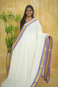 AWB7240 White mul cotton saree features a plain body with purple temple border.