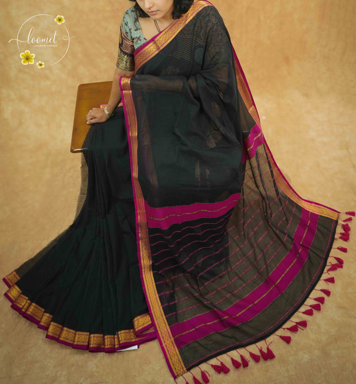 AWB7250 Black mul cotton saree features a plain body with golden zari border.