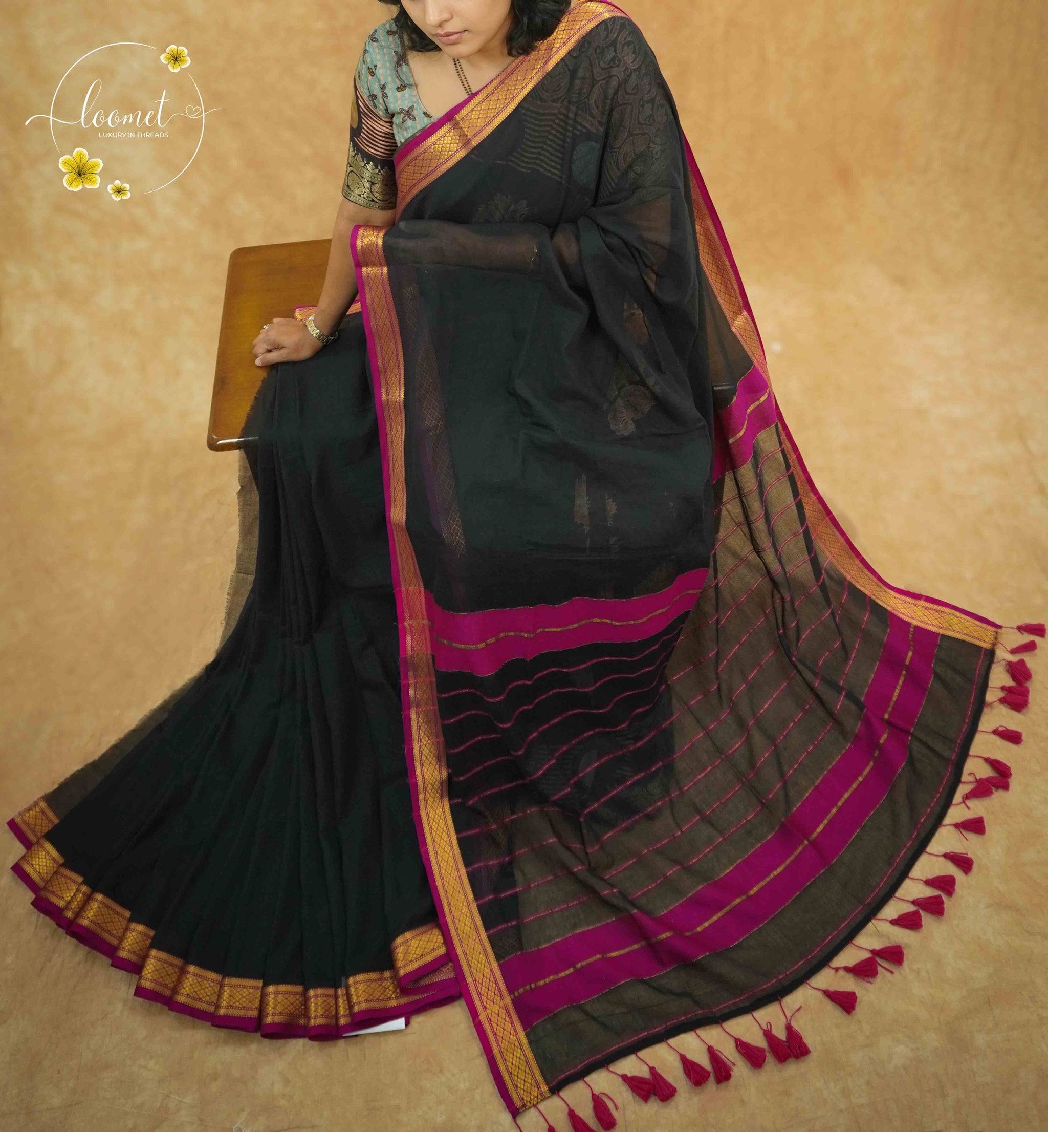 AWB7250 Black mul cotton saree features a plain body with golden zari border.