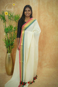 AWB7260 Off-White mul cotton saree features a plain body with multicolored temple border.