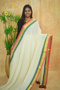 AWB7260 Off-White mul cotton saree features a plain body with multicolored temple border.