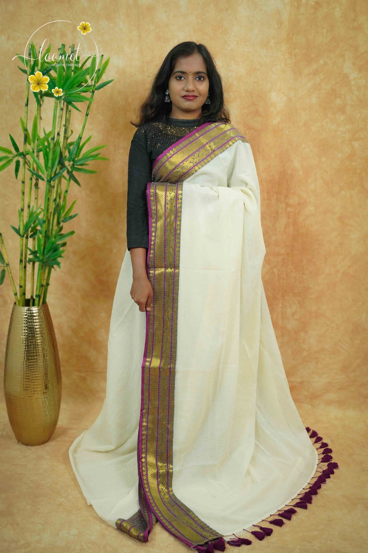 AWB7290 Off-White mul cotton saree features a plain body with wine & golden zari and tassels.