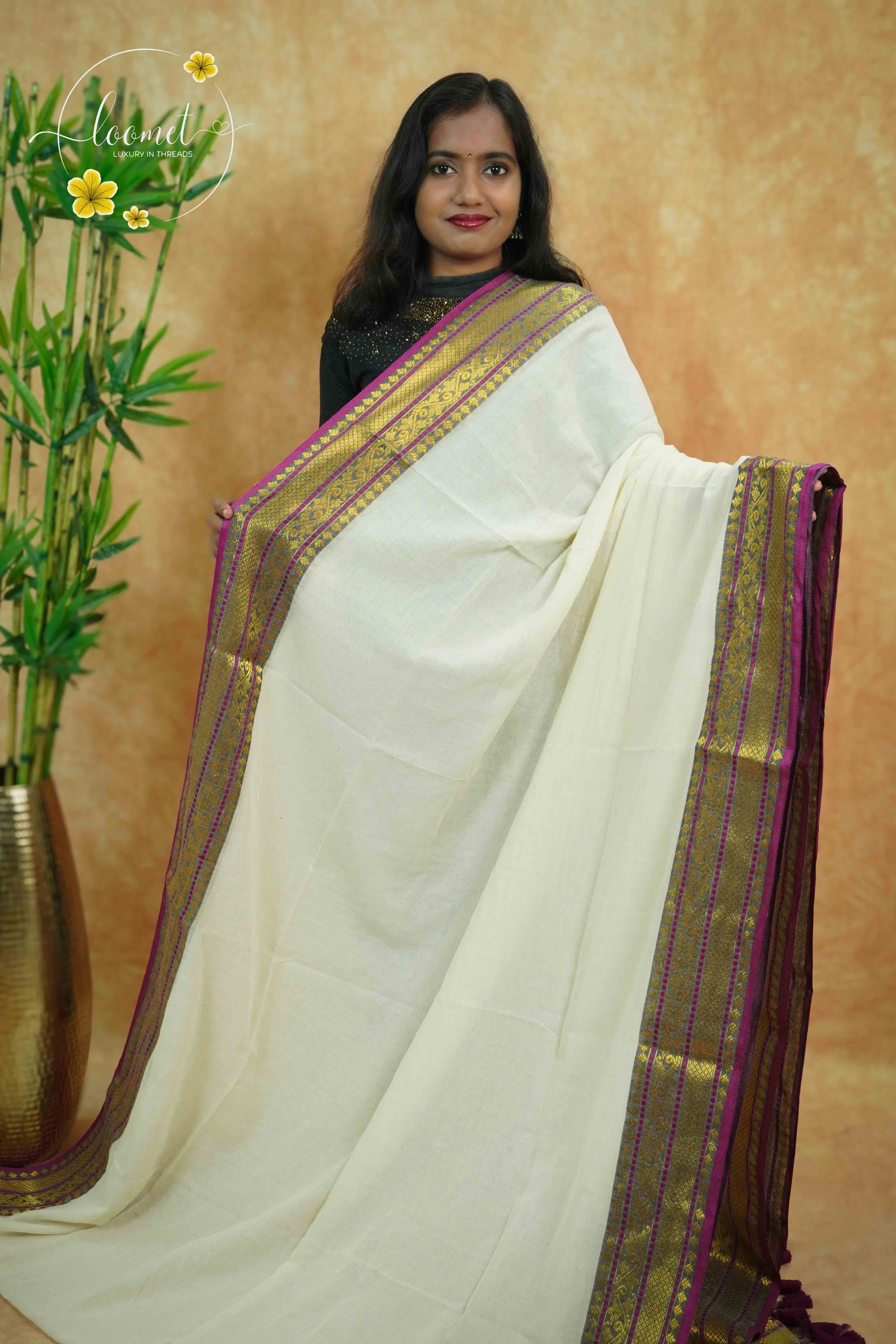 AWB7290 Off-White mul cotton saree features a plain body with wine & golden zari and tassels.
