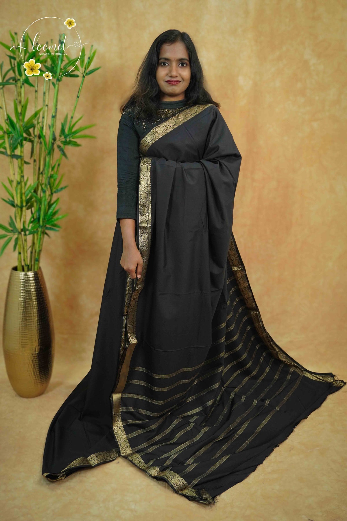 IMC5116 Jet Black Georgette Viscose saree with horizontal gold zari stripes.