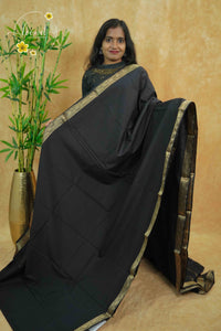 IMC5116 Jet Black Georgette Viscose saree with horizontal gold zari stripes.