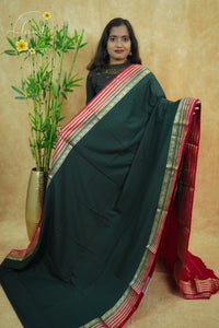 IS6115 Bottle Green and Rani Pink Georgette Viscose saree with floral gold zari border.
