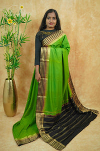 IS6117 Parrot Green and Jet-Black Georgette Viscose saree with floral gold zari border.