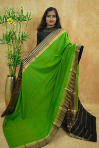 IS6117 Parrot Green and Jet-Black Georgette Viscose saree with floral gold zari border.