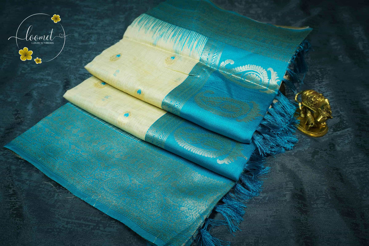 ISS8311 Off-White and turquoise blue Banarasi Semi Cotton saree with floral motifs.