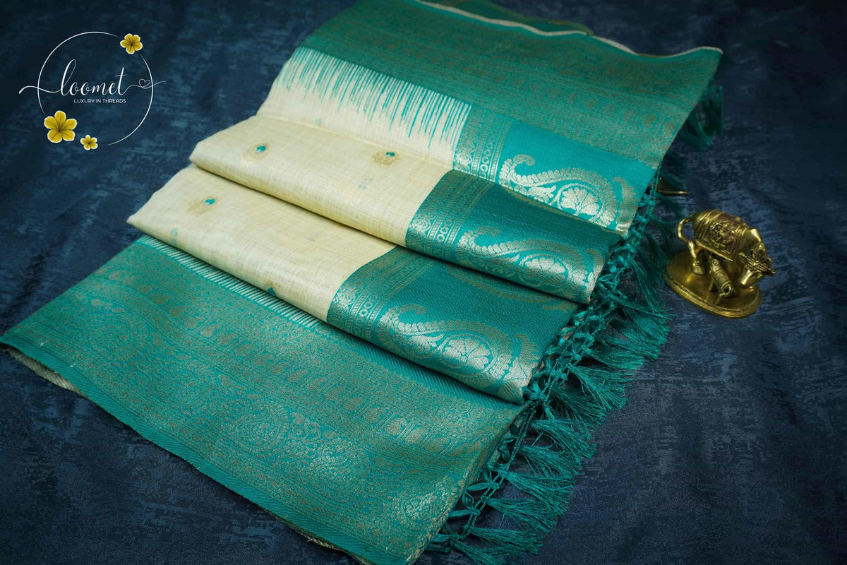 ISS8315 Off-White and teal green Banarasi Semi Cotton saree with floral motifs.