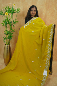IWS4112 Yellow Tissue Organza saree with silver sequin buttas shaped like small leaves.