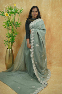 IWS4113 Sage Green Tissue Organza saree with silver sequin buttas shaped like small leaves.