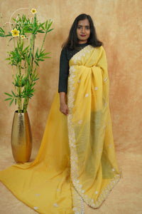 IWS4116 Golden Yellow Tissue Organza saree with silver sequin buttas shaped like small leaves.