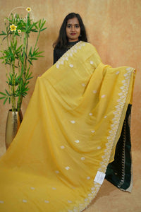 IWS4116 Golden Yellow Tissue Organza saree with silver sequin buttas shaped like small leaves.