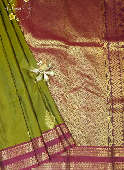 LSK6116 Olive green silk saree with contrasting maroon borders and pallu, densely woven with intricate gold zari patterns.