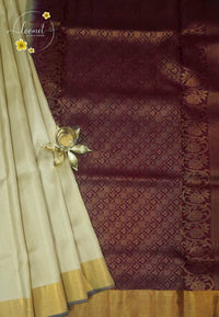 LSK6122 Cream and maroon silk saree contrasted by a dense maroon pallu woven with intricate gold geometric patterns.
