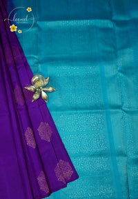 LSK6123 Royal purple and aqua blue silk saree with gold motifs, dramatically contrasting a shimmering blue pallu with intricate woven patterns.